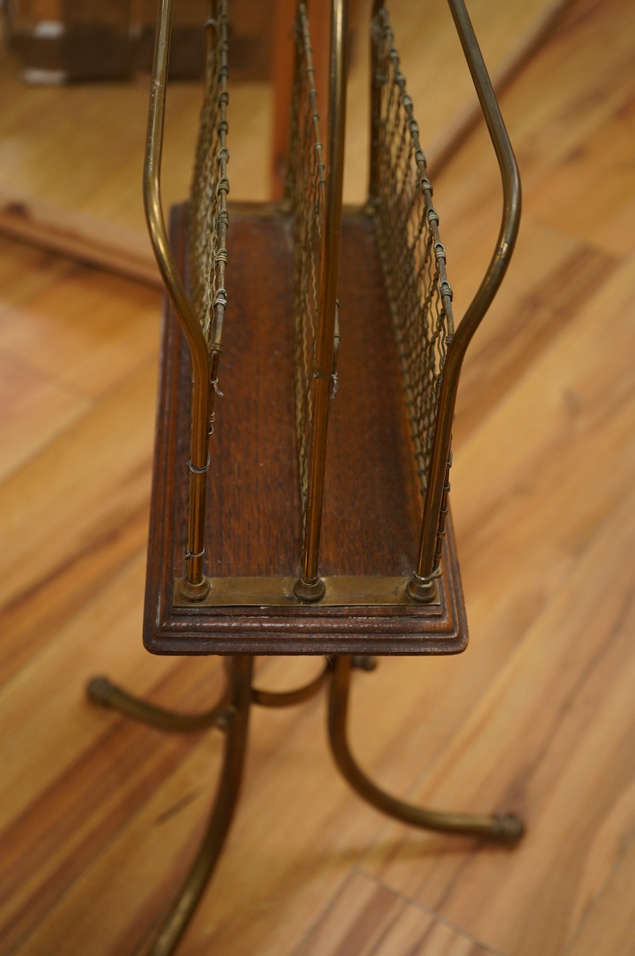 An Edwardian oak and brass paper stand, 76cm. Condition - fair to good